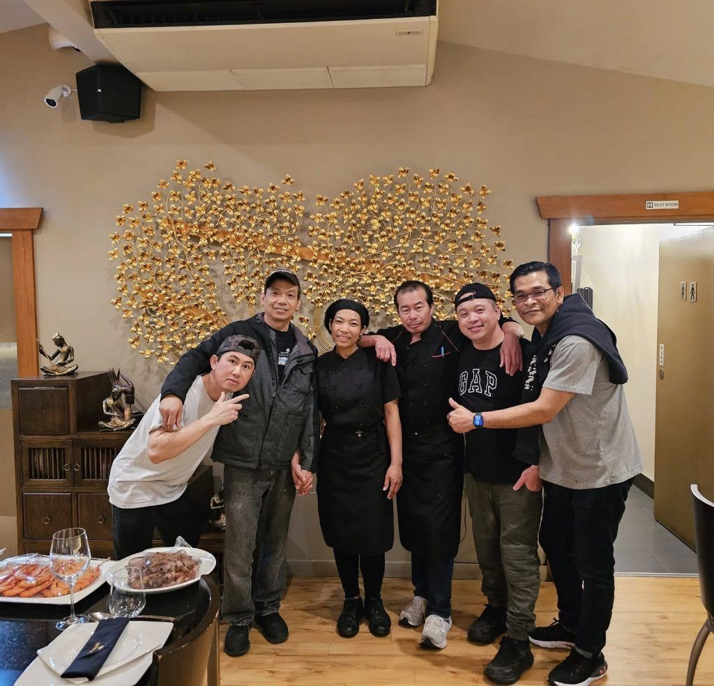 chef siri photo with guests at a birthday party