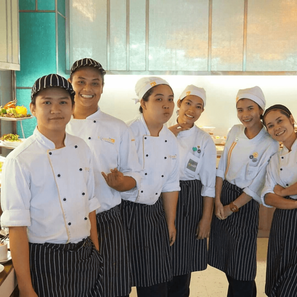 photo fo chef siri and other chefs in chefs uniforms at a fine dining restaurant