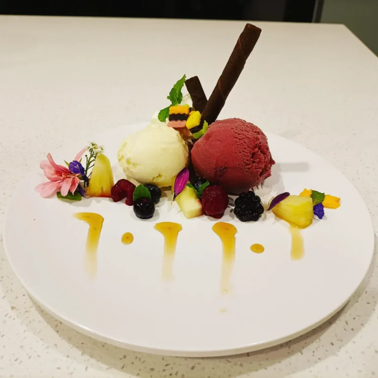 artisan ice cream trio with fresh fruit and edible flowers