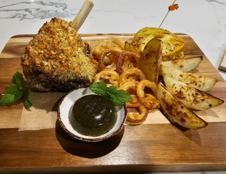 crumbed lamb rack with roasted potatoes pineapple and onion rings