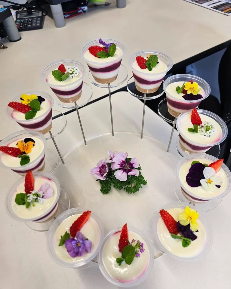 mini layered cheesecakes with berry compote and edible flowers