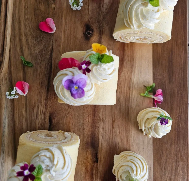 mini-vanilla-swiss-roll-cakes-whipped-cream-edible-flowers-top-view