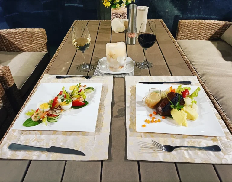 romantic private dining setup with plated meals and wine glasses