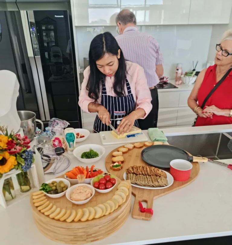 private-chef-preparing-grazing-board-crackers-dips-crudites-home-kitchen-guests
